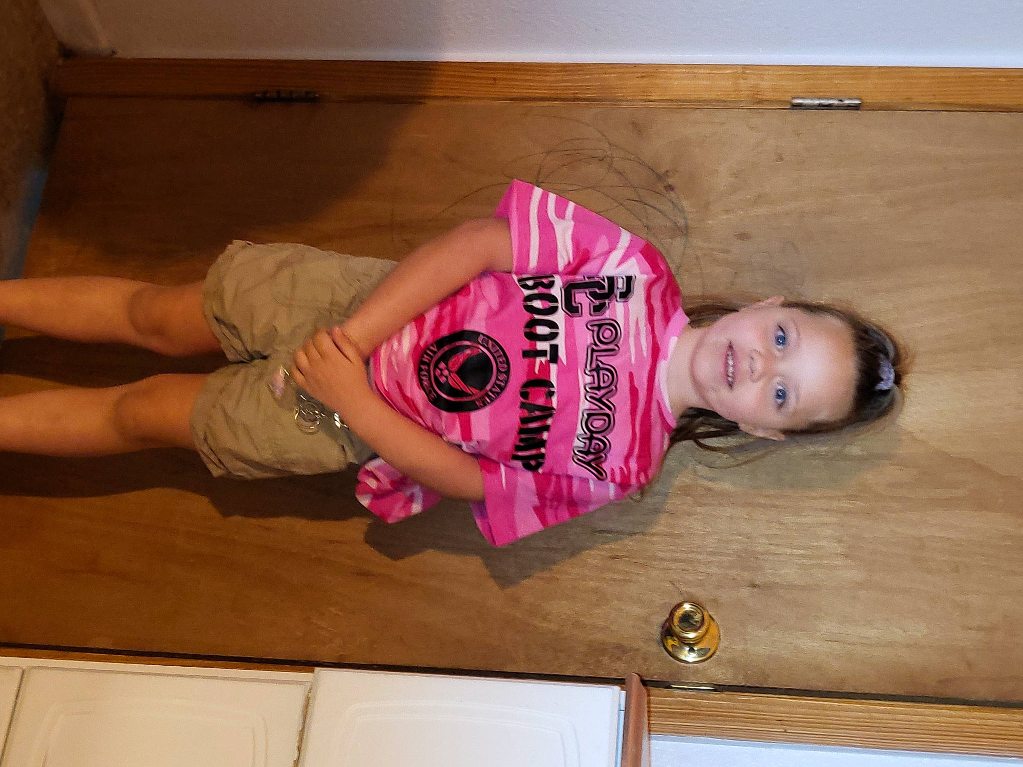 Darian is registered to the contest to win money with this photo: eyelash, facial_expression, finger, floor, flooring, fun, happy, hardwood, human_body, joint, joy, knee, magenta, neck, person, pink, shoulder, sleeve, thigh, waist