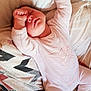 arm_up, baby, bed, blanket, bunny_design, child, cozy, cute, face, home, indoor, infant, onesie, peaceful, person, pillow, pink_clothing, resting, sleeping, soft_texture