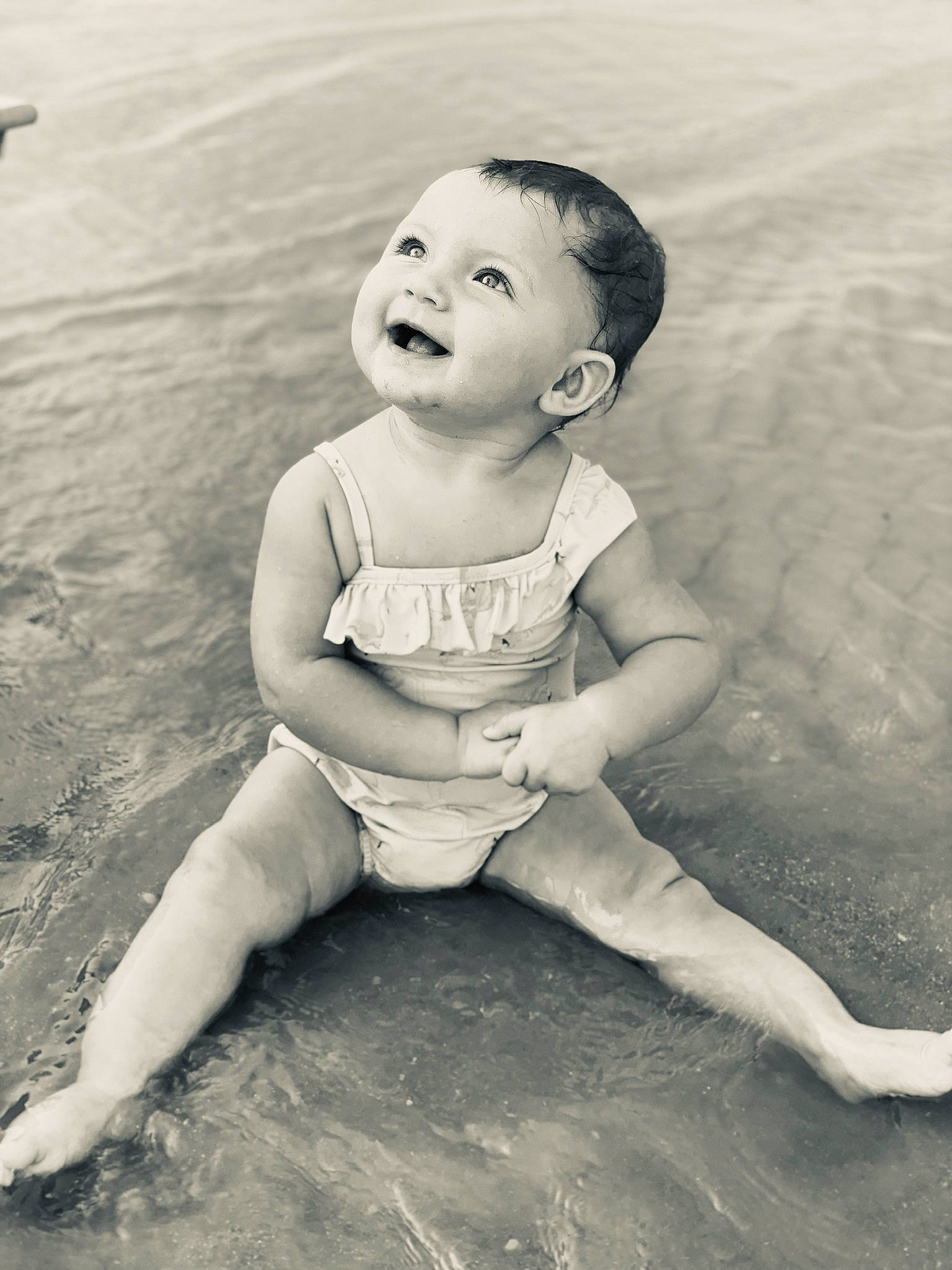 Coralee joined the competition — help win amazing prizes! baby, black_and_white, child, facial_expression, fun, hand, happy, leg, monochrome, person, photograph, photography, play, portrait, sea, skin, smile, snapshot, toddler, vacation