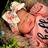 newborn, baby, sleeping, basket, fur, greenery, headband, pink_clothing, peaceful, infant, cute, portrait, child, flora, soft_texture, closeup, resting, adorable, cozy, baby_girl