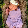 newborn, baby, infant, flower_crown, blanket, purple, basket, fur, greenery, sleeping, wrapped, cute, peaceful, portrait, closeup, indoors, soft_texture, baby_feet, baby_hands, nature_theme