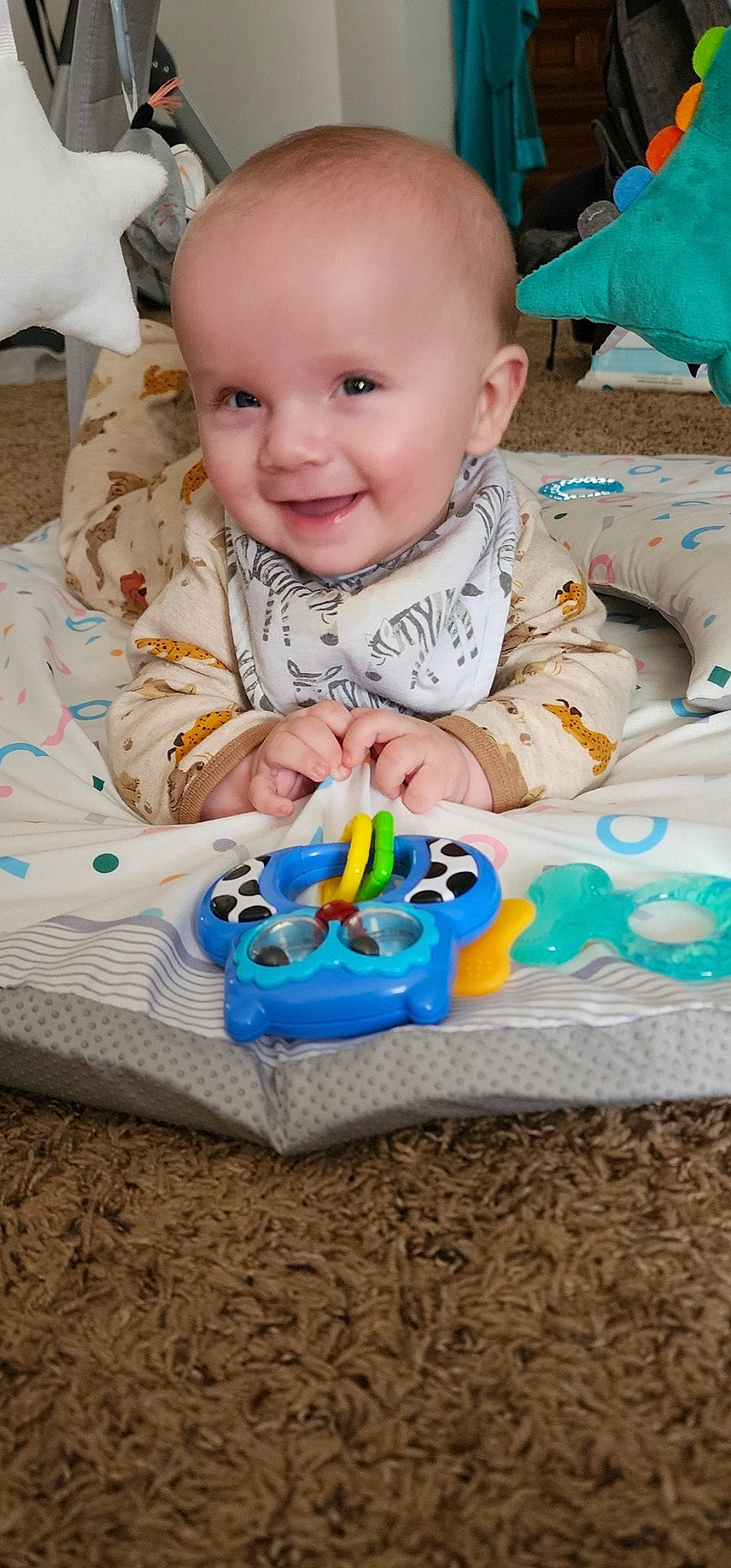 Winston is registered to the contest to win money with this photo: baby, baby_playing_with_toys, baby_products, baby_toddler_clothing, cheek, child, dress, event, face, facial_expression, fun, happy, iris, joy, organ, person, sitting, skin, sleeve, smile
