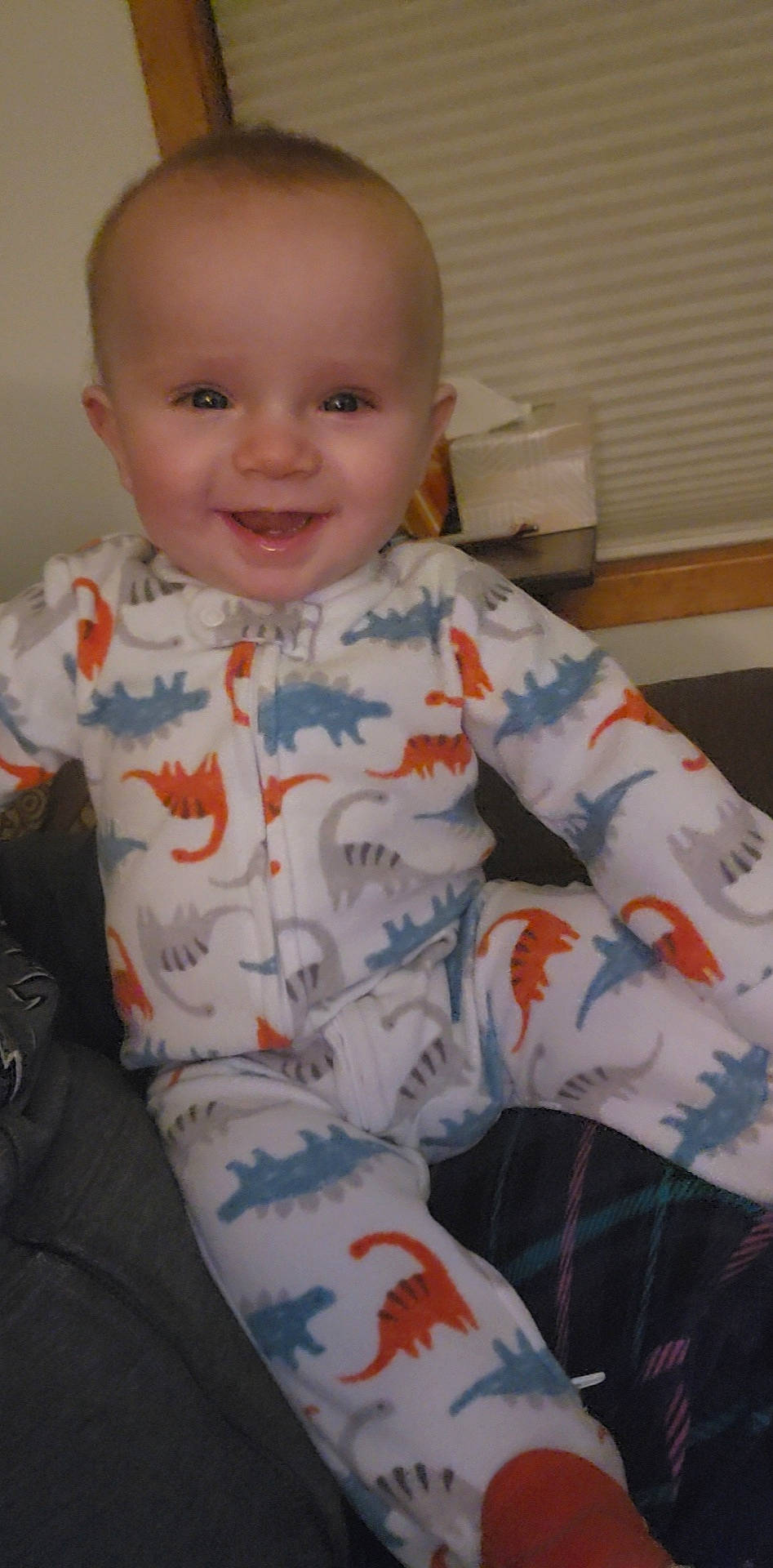 Winston is registered to the contest to win money with this photo: arm, baby_toddler_clothing, cheek, chin, eye, eyebrow, face, facial_expression, hairstyle, head, human_body, iris, joy, lip, mouth, nose, person, skin, sleeve, smile