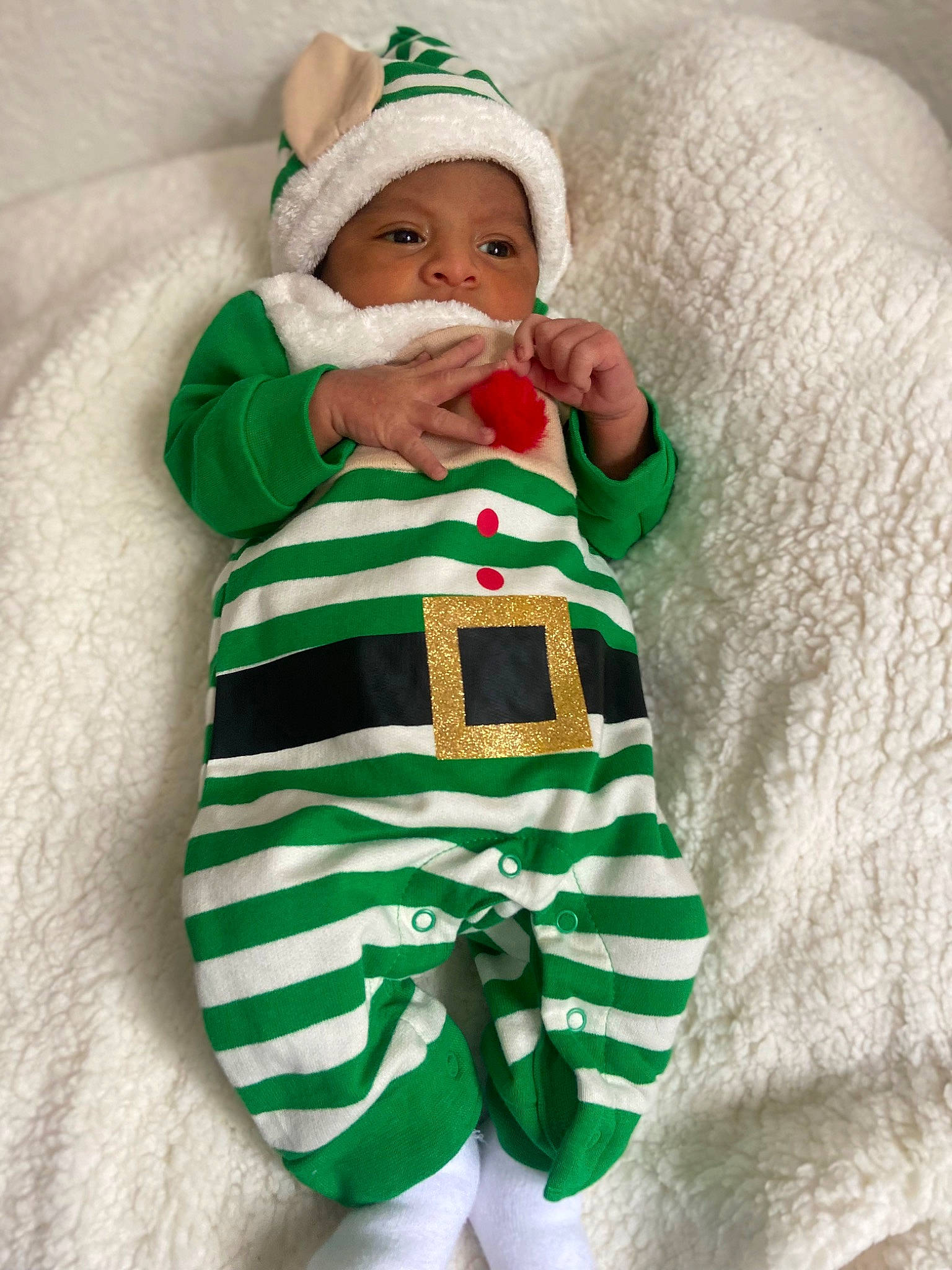 Juan joined the competition — help win amazing prizes! baby, baby_products, baby_sleeping, baby_toddler_clothing, child, comfort, event, face, fictional_character, green, hat, headwear, holiday, leg, linens, pattern, person, santa_claus, sleeve, sock