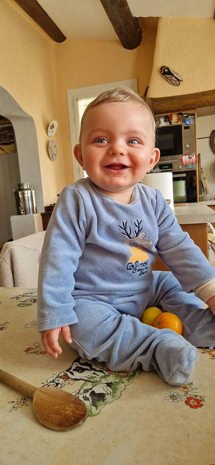 architecture, baby, building, clothing, cutlery, face, food, fruit, furniture, head, indoors, livingroom, pants, person, photography, plant, portrait, produce, room, spoon