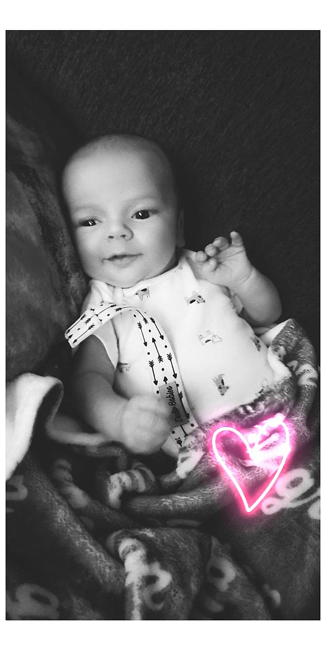 Grayson is registered to the contest to win money with this photo: baby, baby_toddler_clothing, black_and_white, cheek, child, darkness, eyebrow, flash_photography, happy, iris, lip, monochrome, monochrome_photography, pattern, person, sitting, skin, still_life_photography, stock_photography, style