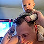 Damon is registered to the contest to win money with this photo: baby, man, tattoo, indoor, shoulders, playful, grip, smile, happy, child, person, skin, hair, closeup, face, expression, holding, casual, interaction, bonding
