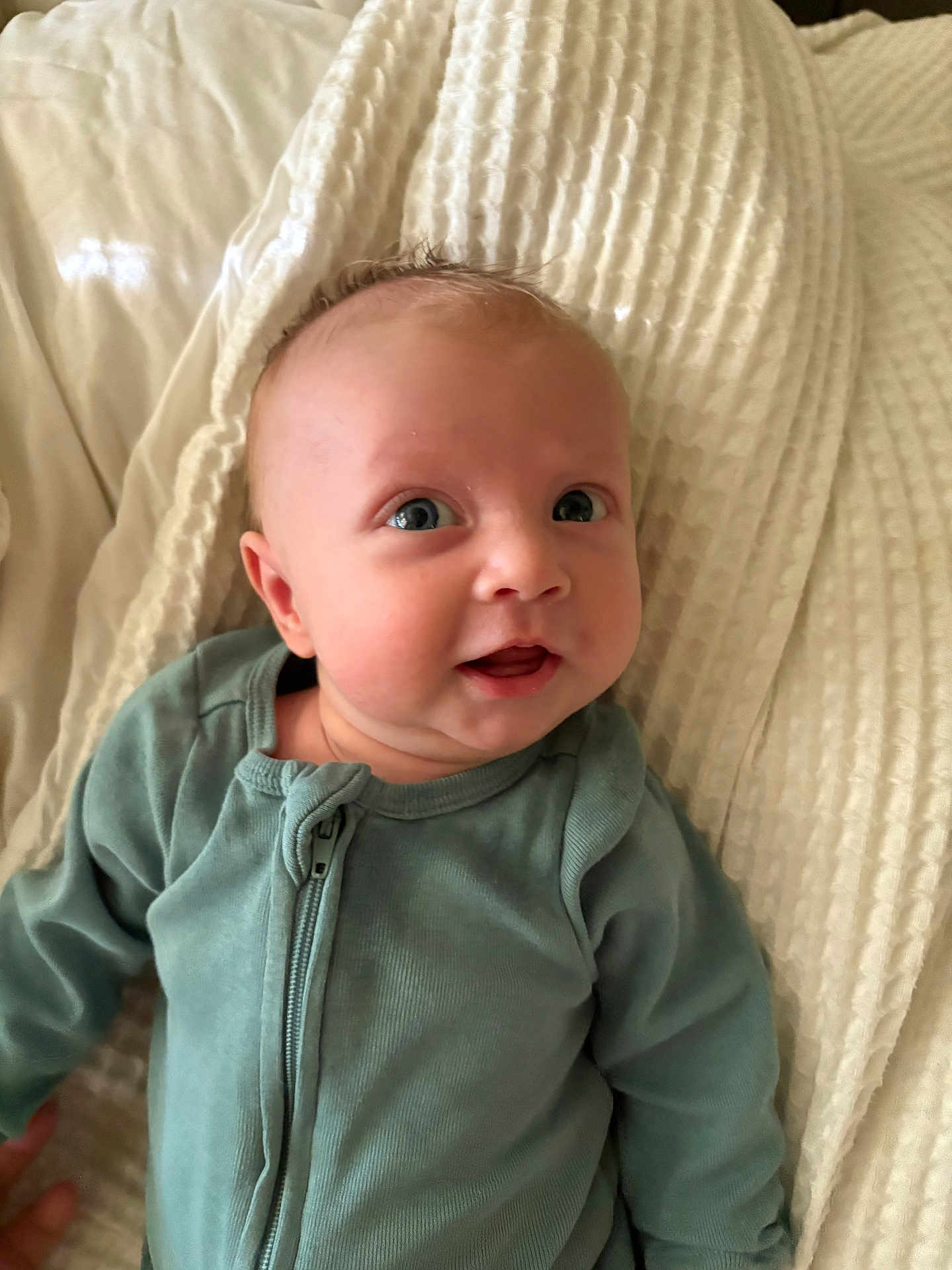 Damon joined the competition — help win amazing prizes! baby, infant, child, face, blue_eyes, clothing, onesie, blanket, texture, soft, cute, portrait, smiling, happy, indoors, person, young, skin, expression, lying_down