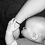 baby, infant, pacifier, arm, hand, skin, striped_clothing, black_and_white, sleeping, closeup, child, person, cute, peaceful, tender, intimate, resting, human, portrait, baby_grip
