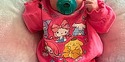 Izabella is registered to the contest to win money with this photo: baby, pacifier, headband, bow, pink_clothing, hello_kitty, blanket, infant, cute, child, apparel, sitting, indoors, portrait, soft_texture, pastel_colors, clothing, face, young_child, toy_character