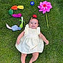 Leya participe au concours pour gagner de l'argent avec cette photo : baby, child, grass, outdoor, plush_toys, vegetables, pinwheel, smile, dress, barefoot, playtime, colorful, happy, summer, nature, toy, greenery, cute, infant, relaxing
