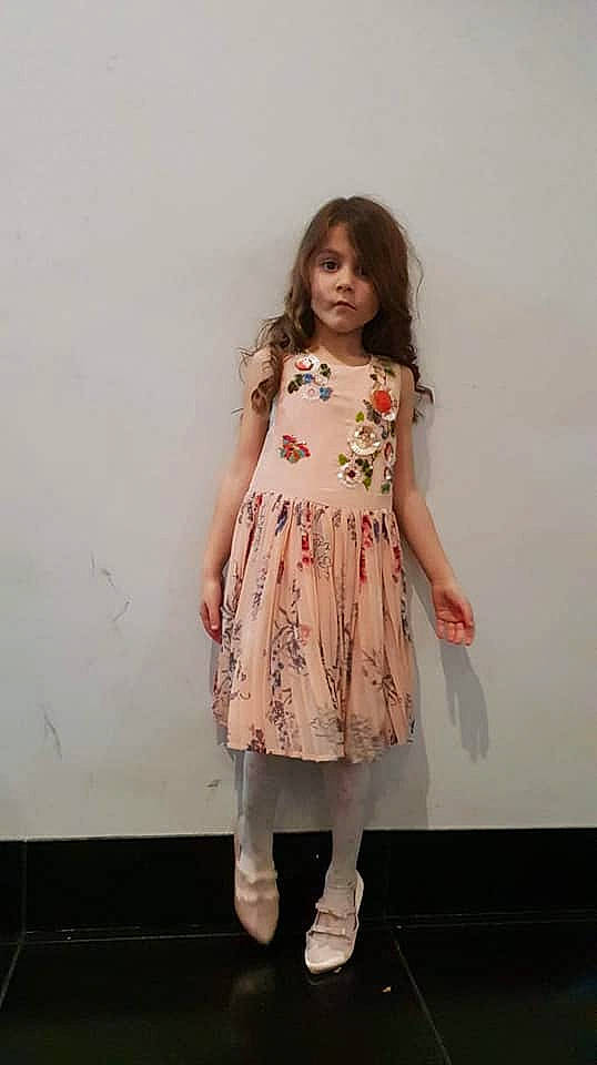 Amelia-rose is registered to the contest to win money with this photo: beige, child, child_model, clothing, day_dress, dress, fashion_design, fawn, pattern, peach, person, sleeve, tights
