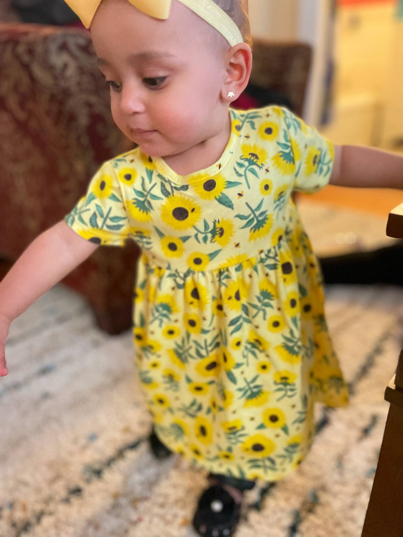 Riley is registered to the contest to win money with this photo: baby, baby_toddler_clothing, child, chin, clothing, dress, eye, face, finger, fun, hairstyle, happy, head, person, skin, sleeve, smile, standing, t_shirt, toddler