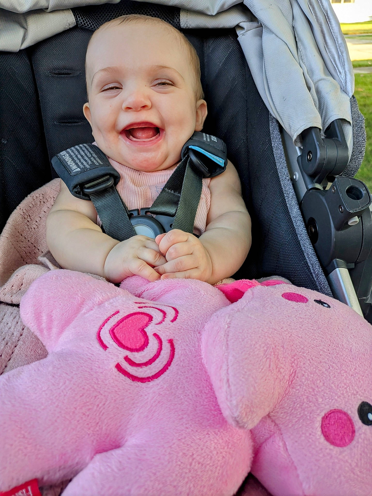 Arya is registered to the contest to win money with this photo: baby, baby_carriage, baby_in_car_seat, baby_toddler_clothing, car_seat, cheek, comfort, cool, facial_expression, finger, gesture, happy, joy, person, photograph, pink, product, skin, smile, thumb