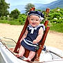 baby, child, smiling, sailor_outfit, hat, wooden_chair, boat, outdoor, greenery, mountains, nature, happy, portrait, cute, infant, summer, sunny, feet, person, scenic