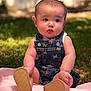 baby, child, denim_overalls, butterfly_print, pink_blanket, outdoor, grass, curious_expression, soft_shoes, cute, chubby_cheeks, sitting, portrait, daylight, nature, infant, young_child, casual_clothing, greenery, innocence