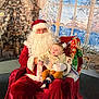 santa_claus, baby, child, christmas, holiday, festive, costume, beard, red_clothing, chair, indoor, decorations, tree, winter, window, curtain, glasses, smiling, person, seasonal