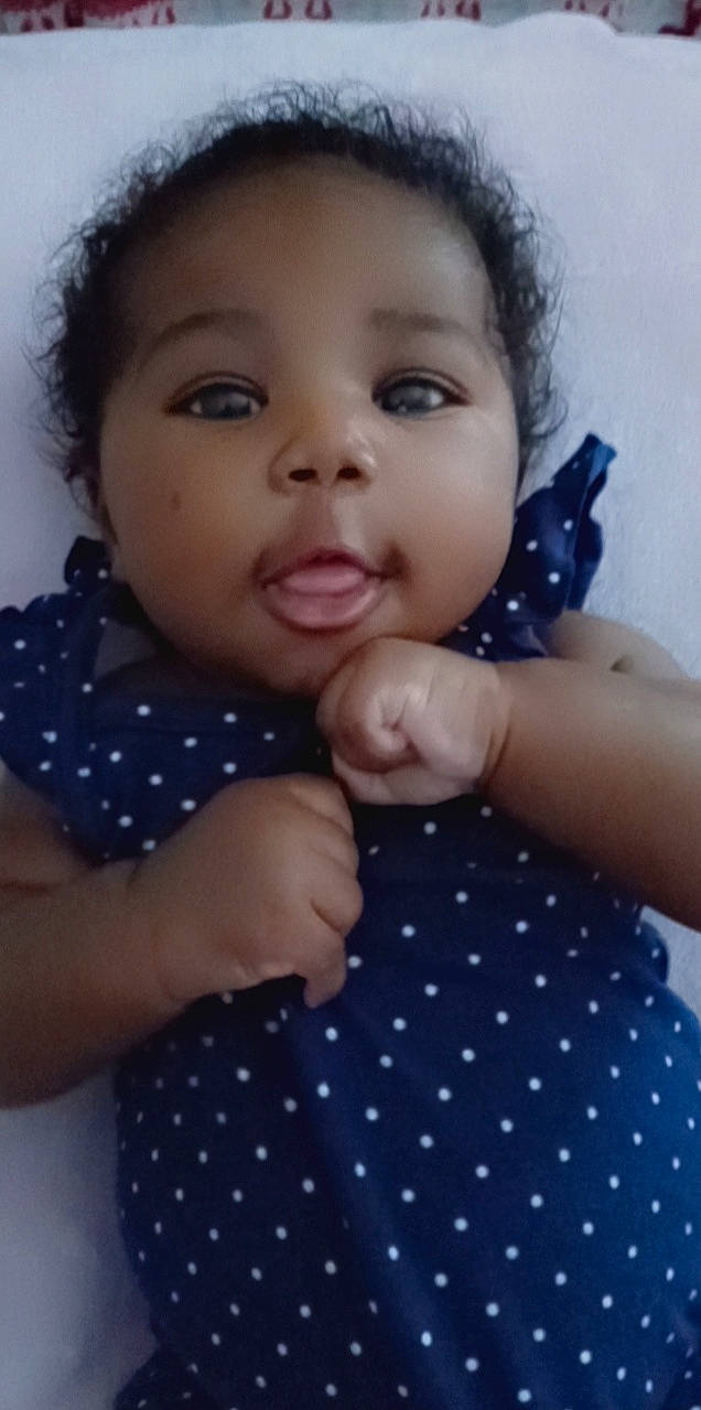 Zola is registered to the contest to win money with this photo: arm, baby_toddler_clothing, blue, cheek, clothing, eyelash, finger, hairstyle, hand, joint, lip, neck, nose, organ, person, product, shoulder, skin, sleeve, standing