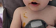 Michael is registered to the contest to win money with this photo: baby, child, blue_eyes, high_chair, food_stains, curious, indoor, face, skin, person, table, hair, expression, closeup, seat, messy, cute, infant, portrait, sitting
