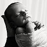 baby, black_and_white, blanket, calm, closeup, cozy, cute, gentle, hand, infant, monochrome, newborn, parent_hand, peaceful, portrait, skin_texture, sleeping, soft_light, tiny_hands, wrapped