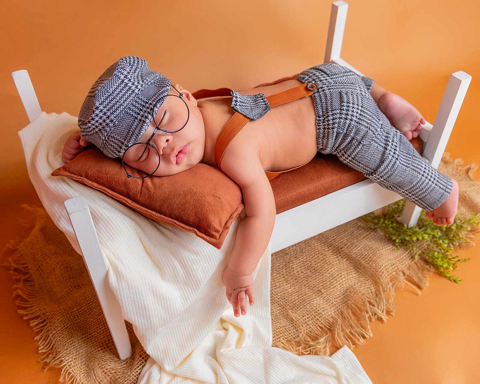 Nathan is registered to the contest to win money with this photo: baby, blanket, cap, clothing, cushion, glove, hat, homedecor, infantbed, person, shorts, sleeping, spa, sunbathing