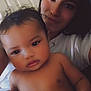Mileena is registered to the contest to win money with this photo: baby, child, woman, portrait, indoor, closeup, face, skin, hair, person, smile, curly_hair, expression, holding, toddler, casual_clothing, necklace, relaxing, together, family
