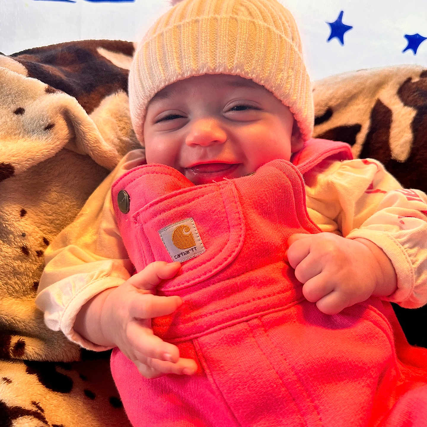 Emery is registered to the contest to win money with this photo: baby, beanie, bodypart, cap, clothing, coat, face, finger, glove, hand, happy, hat, head, jacket, laughing, pants, person, photography, portrait, smile