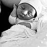 baby, beanie, bed, black_and_white, blanket, cheeks, closeup, cozy, face, hat, infant, monochrome, newborn, peaceful, portrait, resting, sleeping, soft_texture, swaddle, tiny_hand