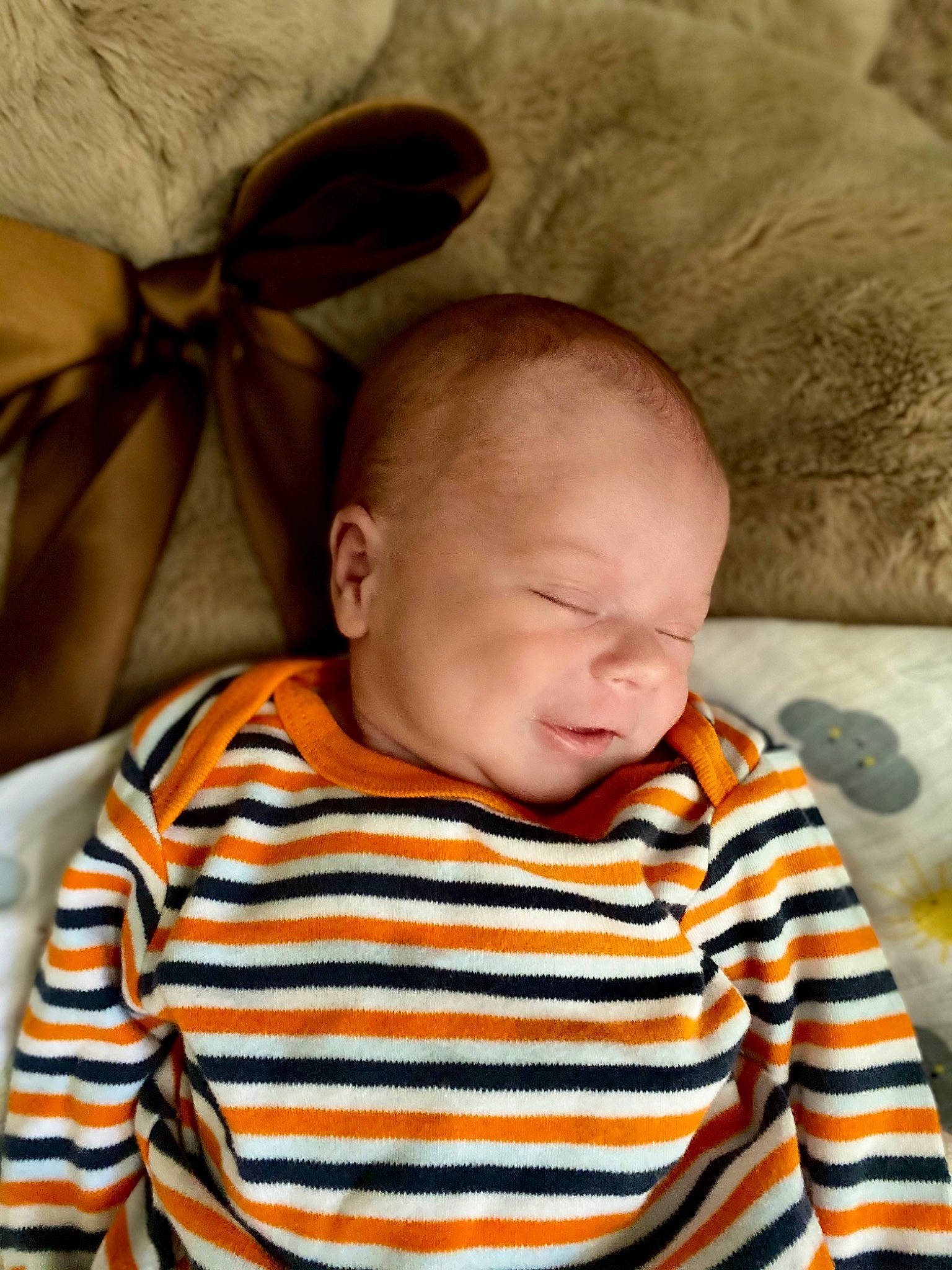 Jude is registered to the contest to win money with this photo: baby, baby_toddler_clothing, cheek, child, comfort, fun, grass, happy, head, linens, nose, person, portrait_photography, room, sitting, sleeve, smile, t_shirt, toddler, tree