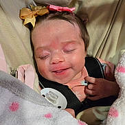 Arya joined the competition — help win amazing prizes! baby, infant, sleeping, hair_bow, bow, blanket, polka_dot, pacifier, car_seat, car_seat_strap, onesie, smile, face, hand, eyelashes, soft_fabric, pink, cozy, newborn, indoor