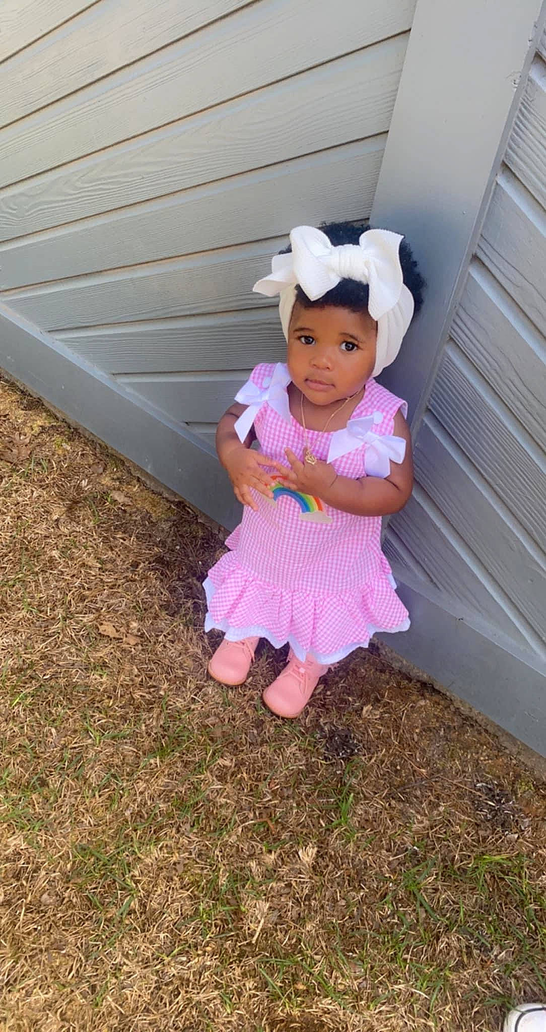 Madilyn is registered to the contest to win money with this photo: baby_toddler_clothing, child, fun, grass, happy, hat, magenta, pattern, people_in_nature, person, pink, play, sitting, sleeve, soil, sun_hat, toddler