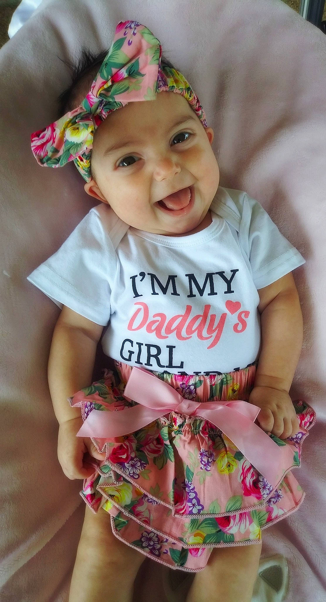 Eden is registered to the contest to win money with this photo: baby, baby_bloomers, baby_products, baby_toddler_clothing, child, fashion_accessory, hair_accessory, headgear, headwear, pattern, person, pink, product, sleeve, smile, toddler