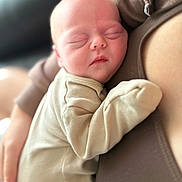 Adeline is registered to the contest to win money with this photo: baby, newborn, sleeping, infant, person, clothing, skin, face, hand, closeup, cozy, rest, tender, comfort, warm, soft_light, indoor, human, sleep, cuddle