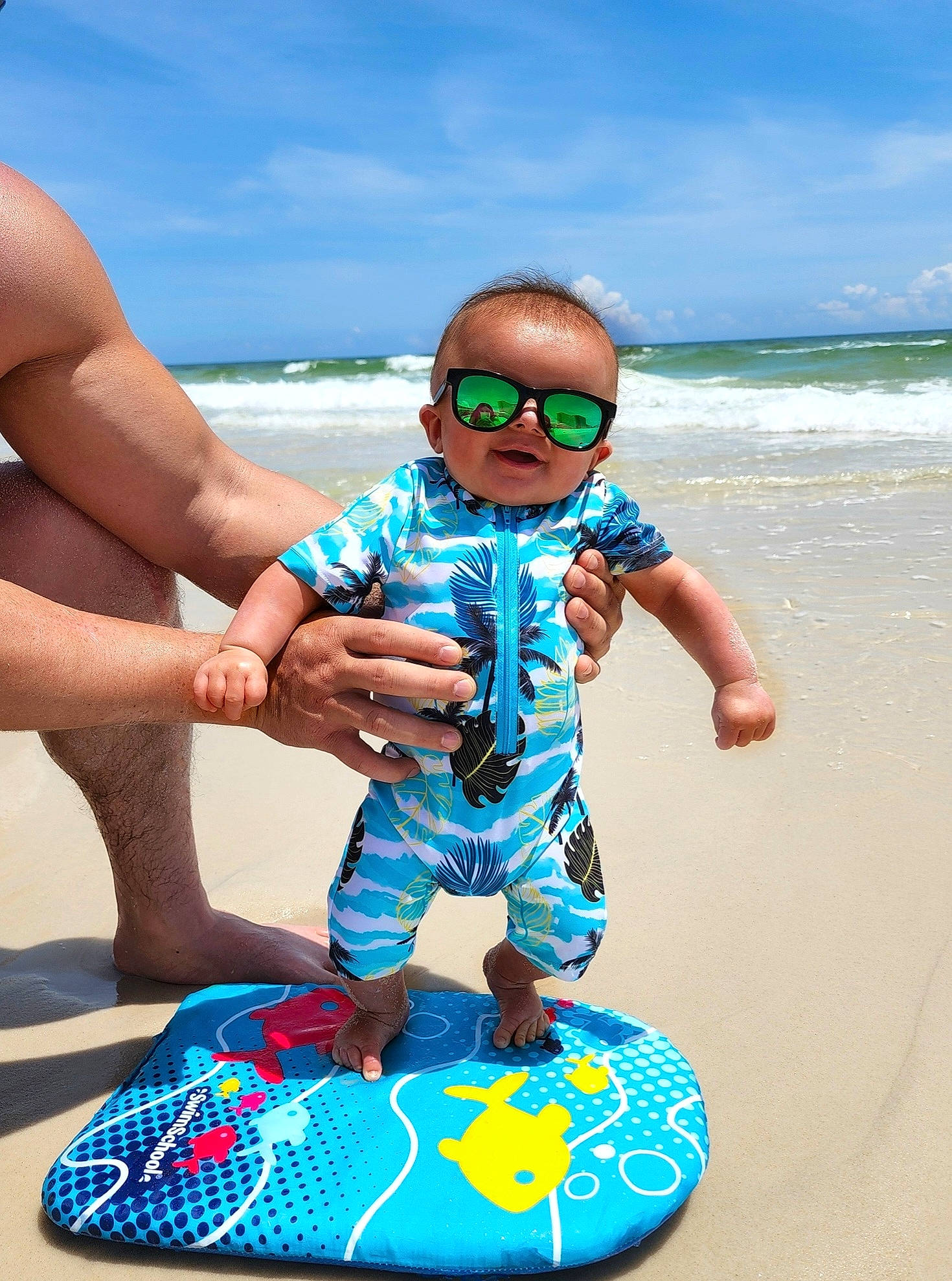 Rylan is registered to the contest to win money with this photo: aqua, azure, baby_toddler_clothing, blue, cloud, electric_blue, eyewear, fun, goggles, happy, leisure, person, personal_protective_equipment, recreation, shorts, sky, sunglasses, thigh, toddler, vision_care