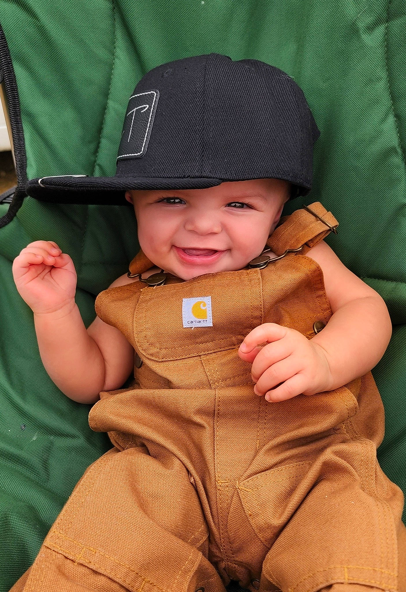 Rylan joined the competition — help win amazing prizes! baby, baby_carriage, baby_products, baby_toddler_clothing, cap, child, comfort, fashion_accessory, hand, happy, hat, headgear, headwear, joy, lap, person, product, sitting, skin, sleeve