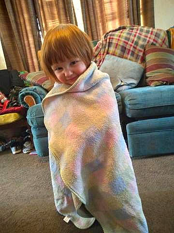 Laylawni is registered to the contest to win money with this photo: comfort, couch, curtain, event, eye, floor, flooring, fur, hardwood, head, joy, lamp, linens, living_room, luggage_and_bags, person, room, sitting, smile, toddler