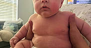 Grayson is registered to the contest to win money with this photo: baby, infant, child, diaper, skin, hands, indoor, window, blinds, couch, person, face, expression, curious, holding, plump, seated, home, soft_light, casual