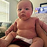 baby, infant, child, diaper, skin, hands, indoor, window, blinds, couch, person, face, expression, curious, holding, plump, seated, home, soft_light, casual