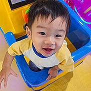 Sean joined the competition — help win amazing prizes! child, toddler, smiling, playground, play_structure, colorful, indoor, happy, face, person, toy, screen, cartoon, yellow, blue, clothing, short_hair, cute, joyful, playroom