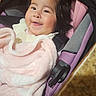 Kaylee is registered to the contest to win money with this photo: baby, child, infant, smiling, happy, portrait, car_seat, blanket, pink, clothing, indoors, sitting, face, eyes, hair, cozy, cuddled, vehicle, photography, joy