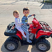 Matthew joined the competition — help win amazing prizes! toddler, child, pajamas, toy_atv, red_vehicle, outdoor, concrete, sunlight, pacifier, sitting, play, vehicle, cute, two_children, baby, daytime, casual, fun, small_vehicle, curious