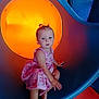 Skylar is registered to the contest to win money with this photo: child, toddler, playground, slide, dress, pink, blue, orange, indoor, play, fun, curious, sitting, barefoot, young, person, expression, colorful, toy, leisure