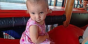 Skylar joined the competition — help win amazing prizes! toddler, child, playground, slide, pink_dress, curly_hair, indoor, netting, play_area, child_playing, red_slide, casual_clothing, expression, young_child, person, fun, activity, bright_colors, curiosity, play