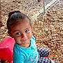 Selena joined the competition — help win amazing prizes! child, smiling, playground, wood_chips, red_chair, blue_shirt, patterned_shorts, outdoor, fence, happy, person, casual_clothing, shorts, plastic_chair, seated, young_child, cute, daylight, play_area, fun
