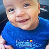 baby, child, smiling, face, blue_shirt, hand, car_interior, person, cute, portrait, happy, young_child, sitting, human, skin, eyes, expression, clothing, infant, holding
