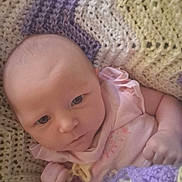 Sophie joined the competition — help win amazing prizes! baby, infant, blanket, crochet, pink_clothing, face, head, skin, hand, cute, newborn, portrait, indoors, cozy, soft, expression, person, child, young, wrapped