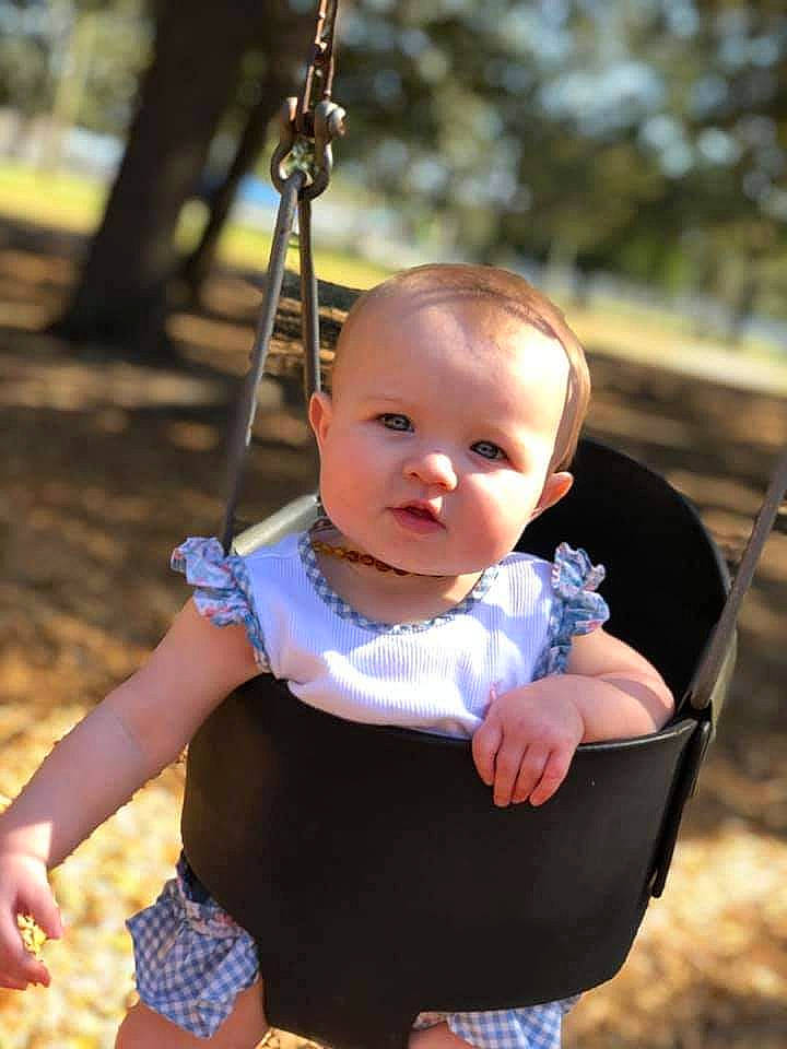 Denise is registered to the contest to win money with this photo: baby, baby_toddler_clothing, black, cheek, child, city, electric_blue, eye, fun, grass, hand, happy, head, leisure, person, photograph, plant, recreation, skin, swing