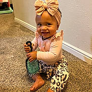 Ryder joined the competition — help win amazing prizes! toddler, child, smiling, hairbrush, bow, headband, pink, leopard_print, pants, carpet, indoor, cute, happy, baby, sitting, long_sleeve, fashion, accessory, skin, person