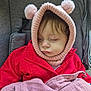 toddler, child, sleeping, hat, knit_hat, pom_poms, red_jacket, blanket, pink_blanket, stroller, gray_stroller, outdoor, cozy, cute, face, warm_clothing, winter, soft_texture, resting, portrait