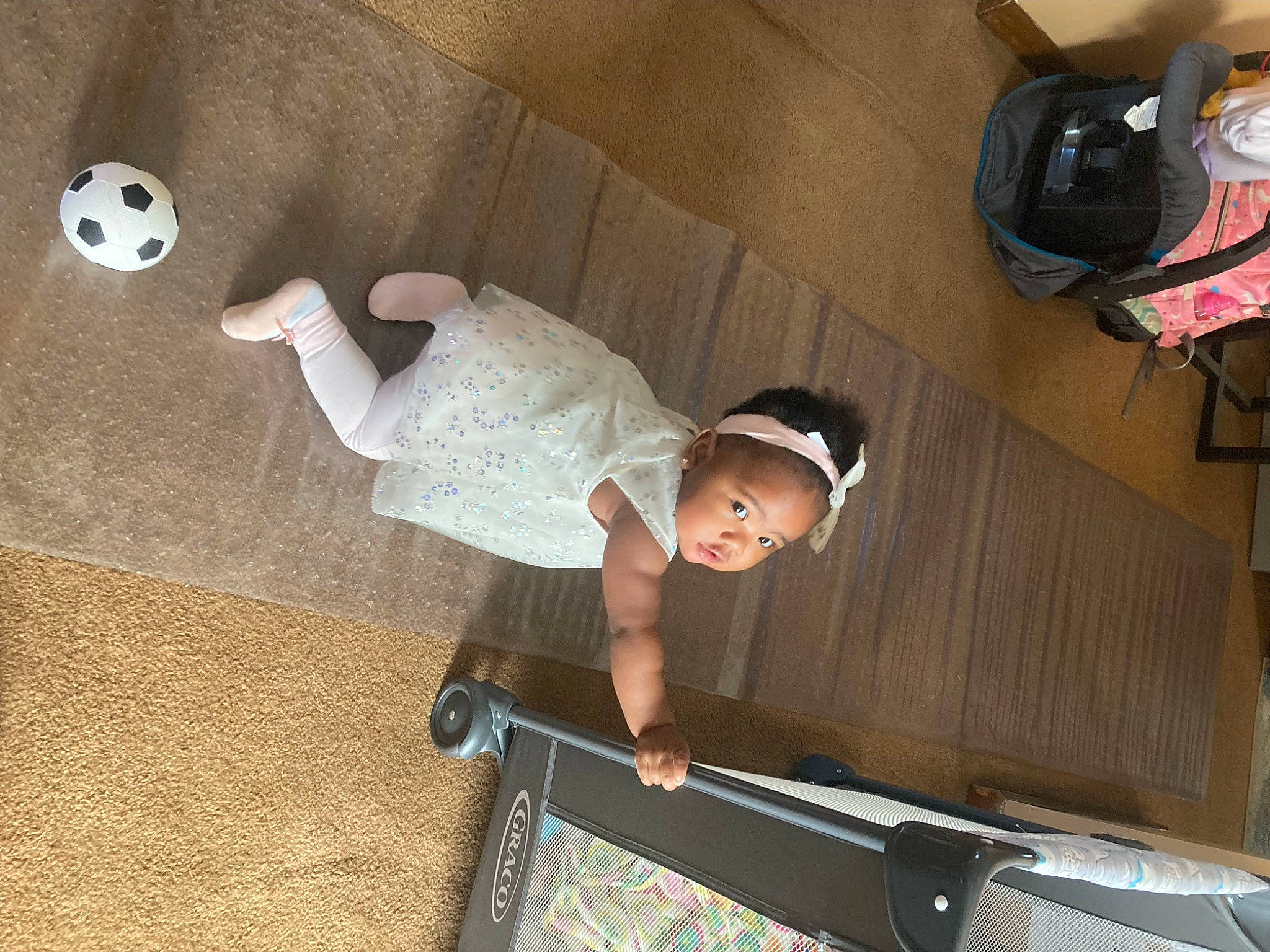 Cevyn is registered to the contest to win money with this photo: baby, baby_products, baby_toddler_clothing, backpack, bag, child, comfort, floor, flooring, fun, hardwood, luggage_and_bags, pattern, person, play, room, sitting, t_shirt, toddler, wood